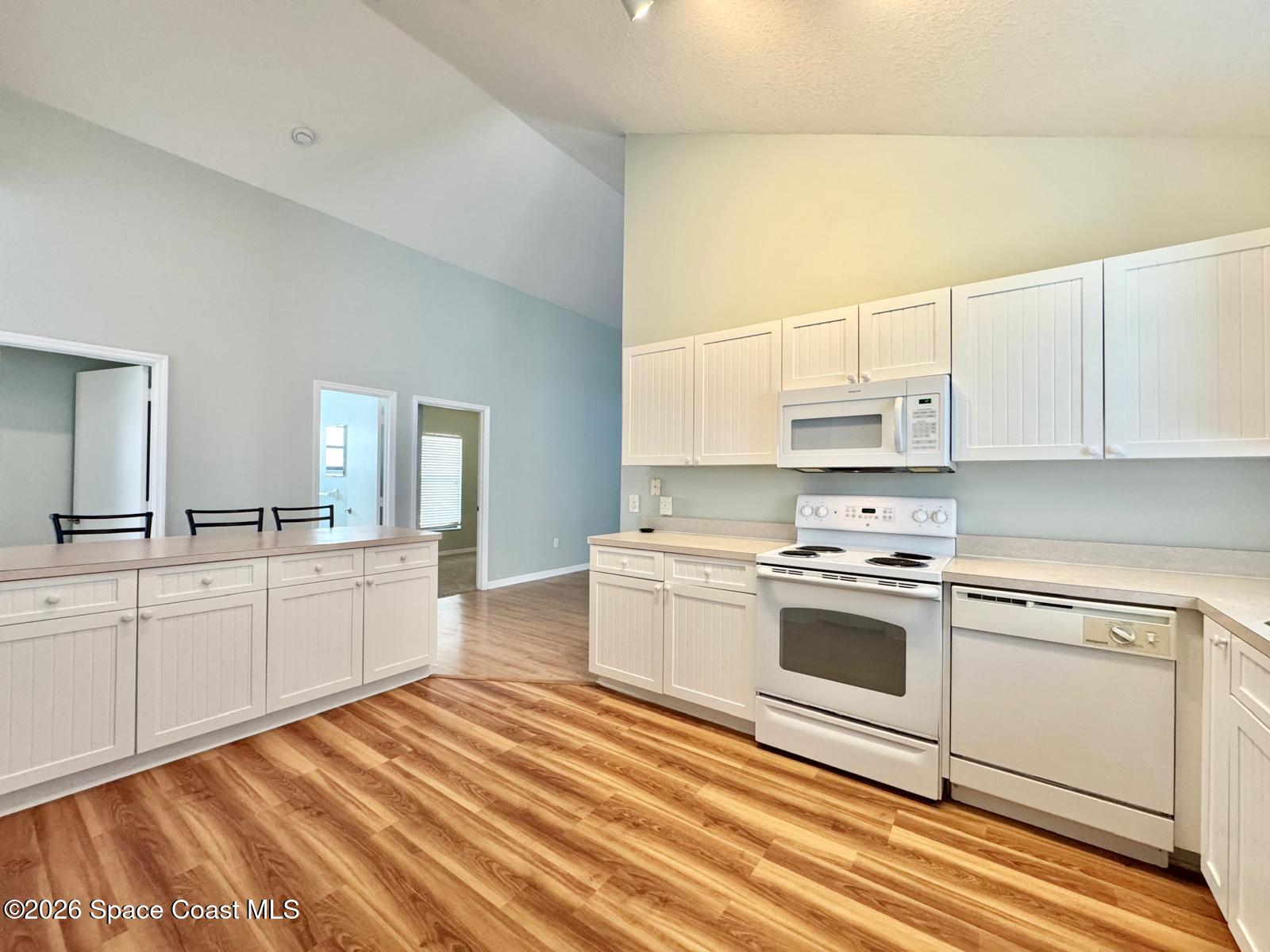 2168 Misty Way Lane Melbourne, FL 32935 - Photo 3 of 19 a kitchen with a stove a sink and a refrigerator
