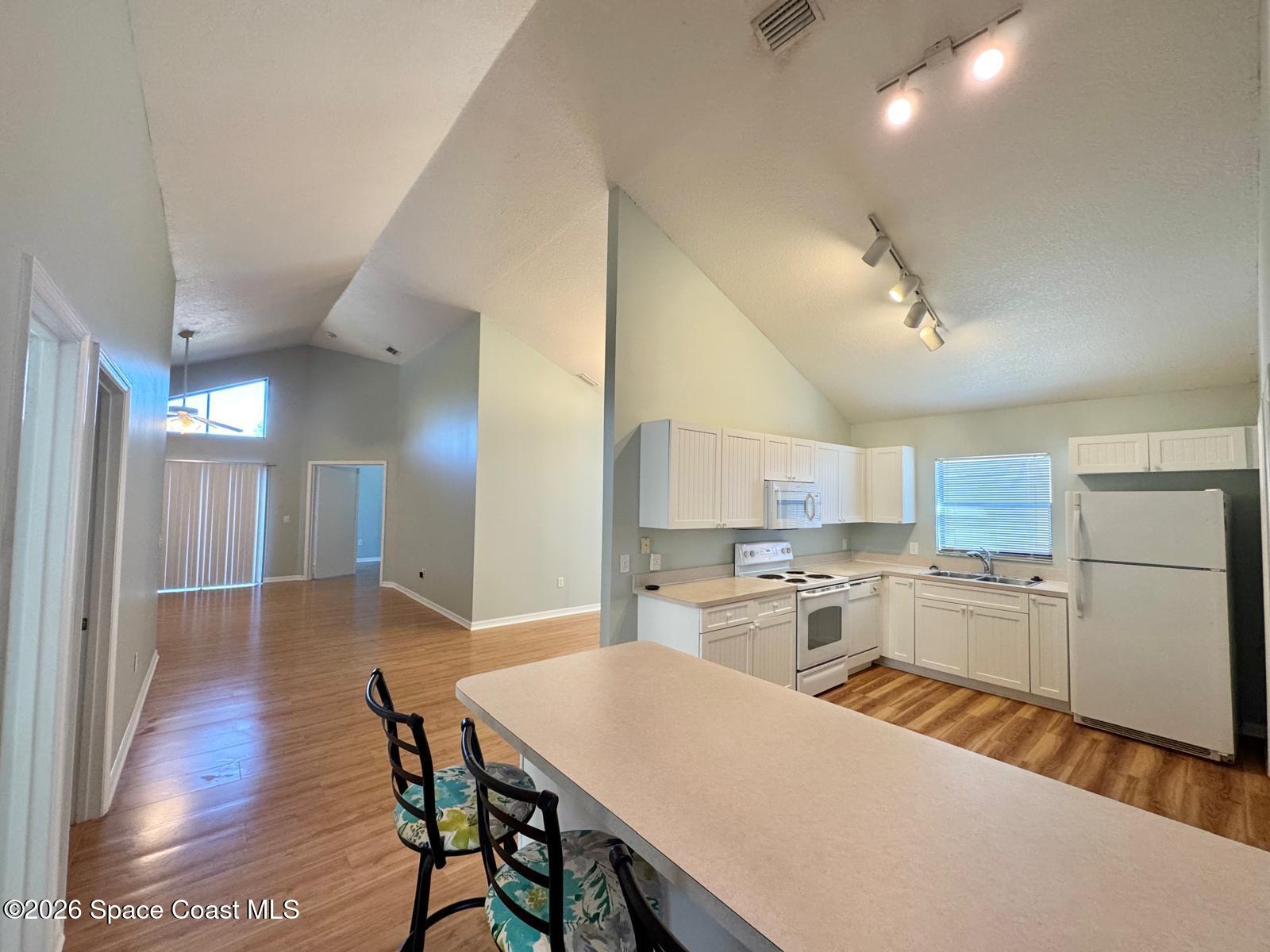 2168 Misty Way Lane Melbourne, FL 32935 - Photo 4 of 19 a kitchen with a table and chairs in it