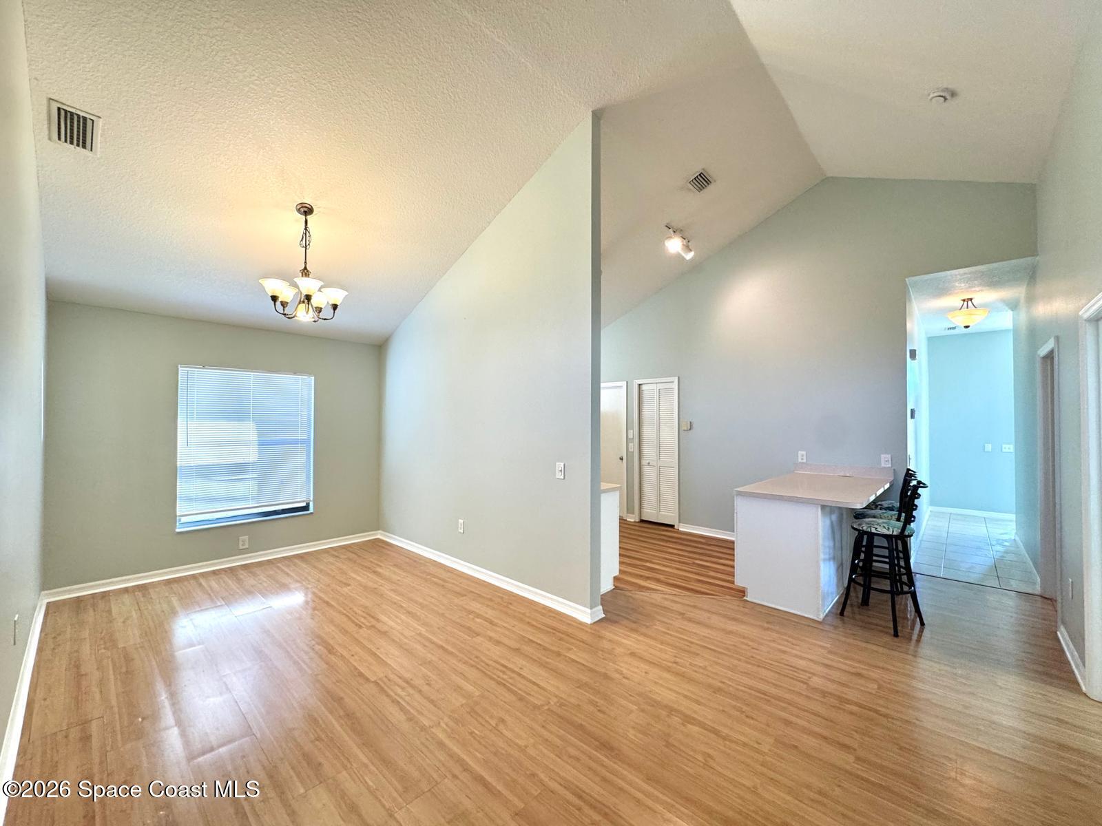 2168 Misty Way Lane Melbourne, FL 32935 - Photo 5 of 19 a view of a room with wooden floor and a window