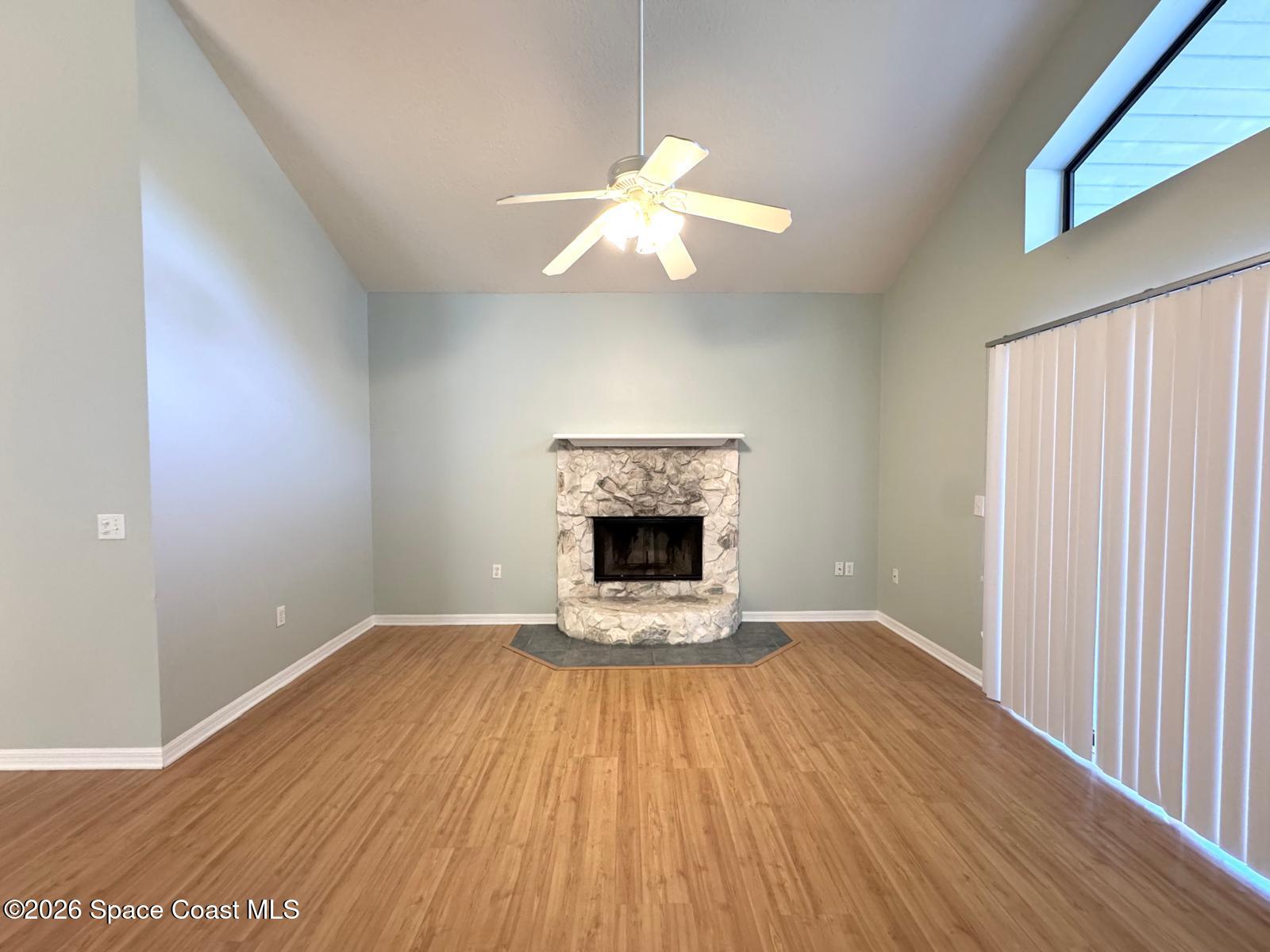 2168 Misty Way Lane Melbourne, FL 32935 - Photo 7 of 19 wooden floor fireplace and natural light in room