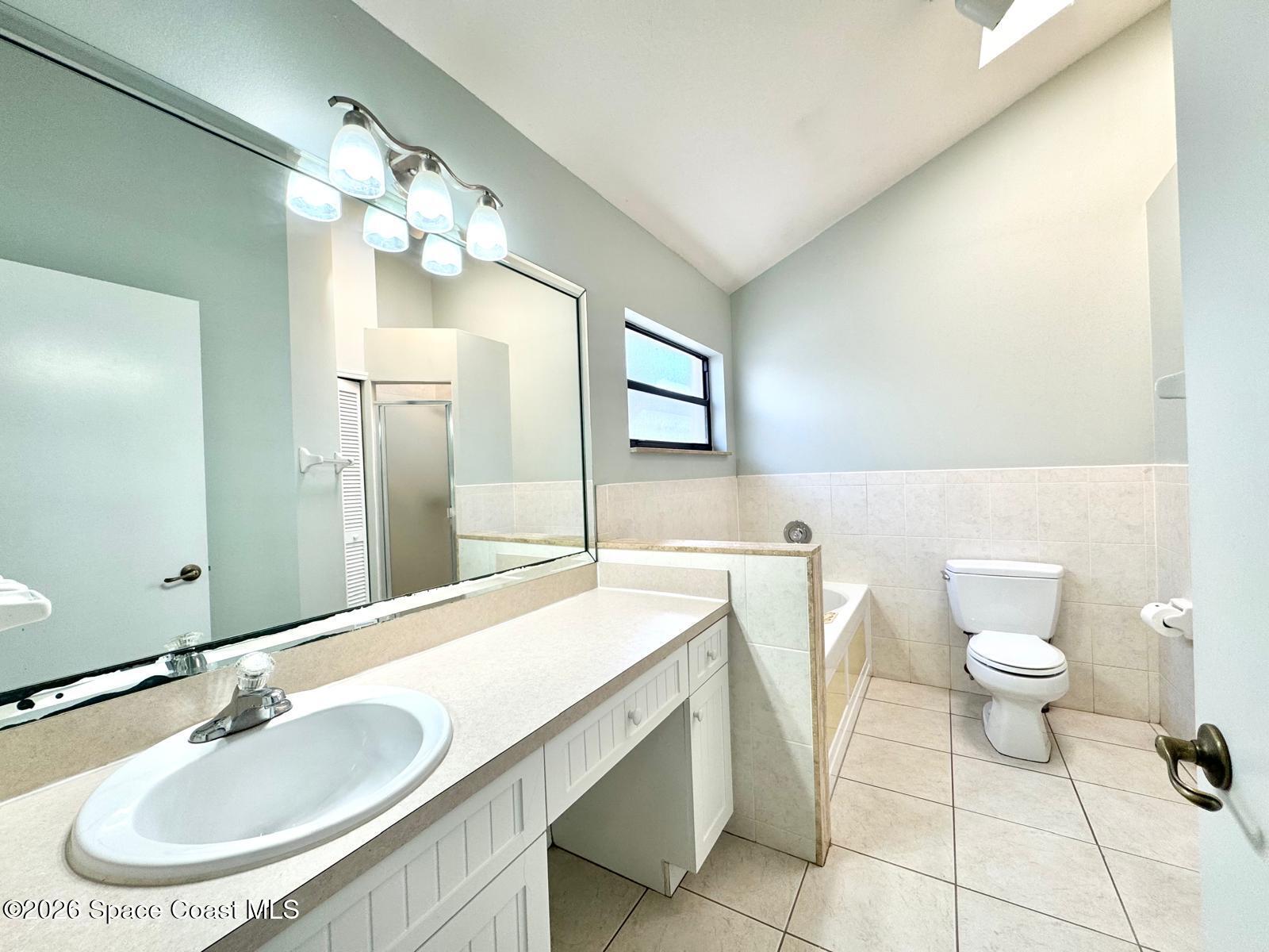 2168 Misty Way Lane Melbourne, FL 32935 - Photo 9 of 19 a bathroom with a sink a toilet and a mirror
