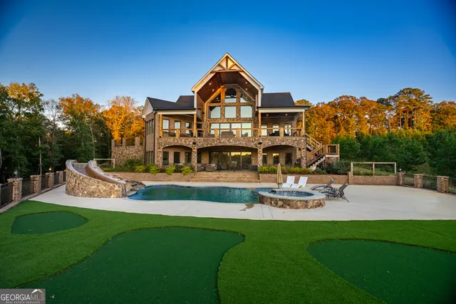 a front view of a house with garden and sitting area
