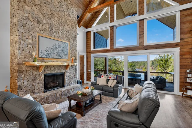 a view of a dining room with furniture a chandelier and wooden floor
