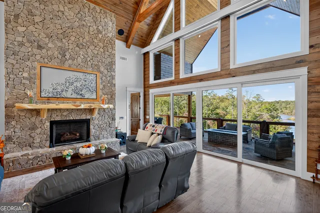 a kitchen with stainless steel appliances granite countertop a sink a refrigerator and a wooden floor