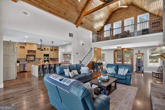 a view of a patio with table and chairs a barbeque with wooden floor and roof