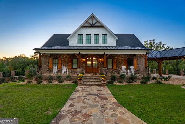 a front view of a house with a yard table and chairs