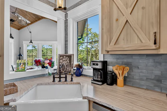 a bathroom with a granite countertop double vanity sink and a mirror