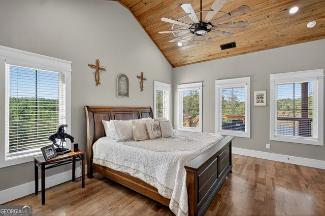an aerial view of a house with garden space and lake view
