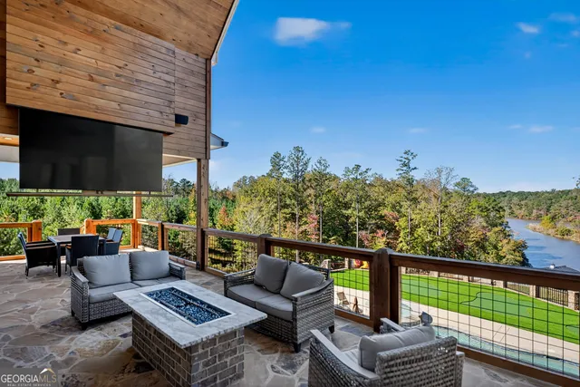 a front view of a house with garden and trees