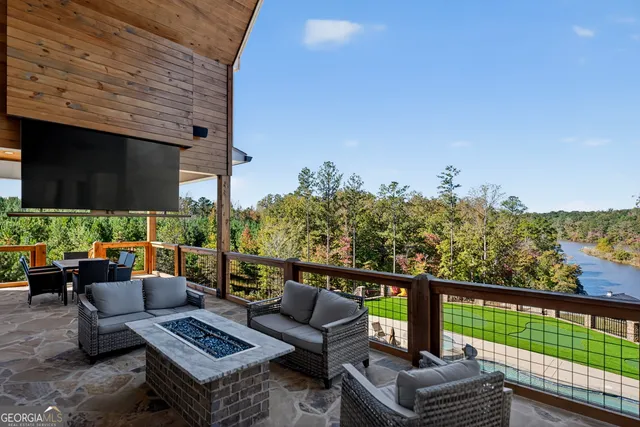 a front view of a house with garden and sitting area