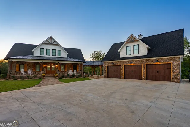 a living room with furniture a fireplace and a large window