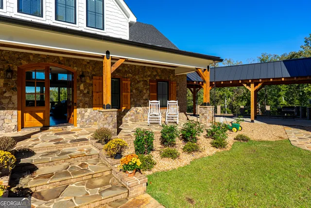 a living room with furniture a fireplace and a large window