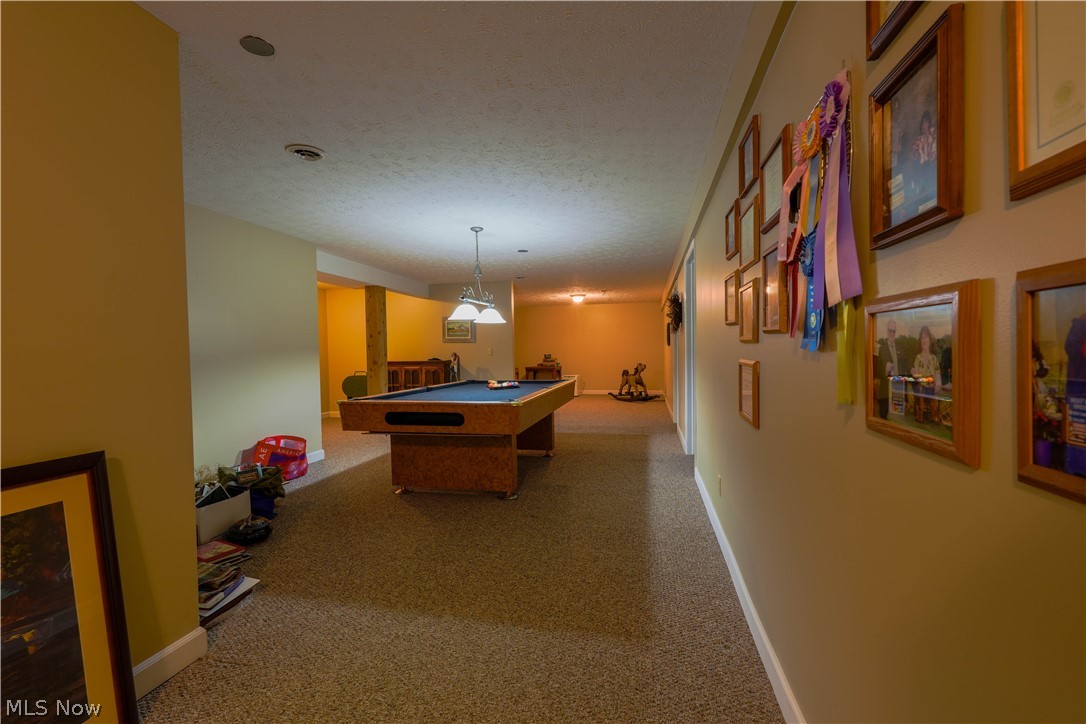 5675 Post Boy Road Southwest Newcomerstown, OH 43832 - Photo 21 of 26 Playroom featuring billiards, a textured ceiling, and carpet flooring