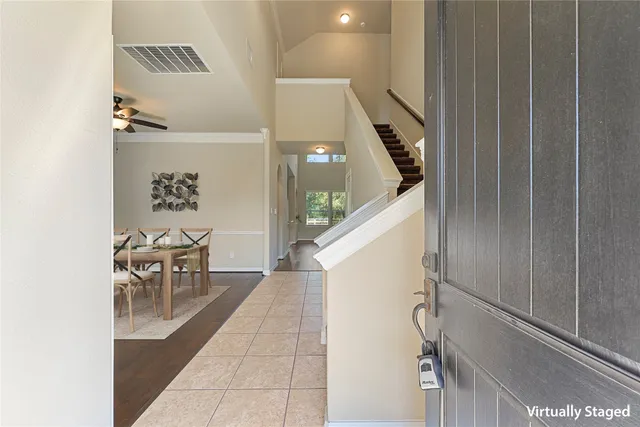 a hallway with dining room and stairs