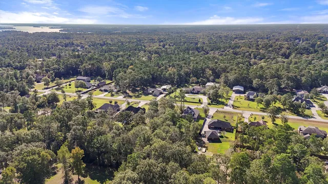 an aerial view of residential houses with outdoor space and swimming pool