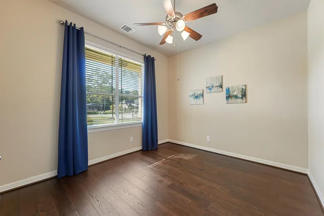 wooden floor in an empty room with a window