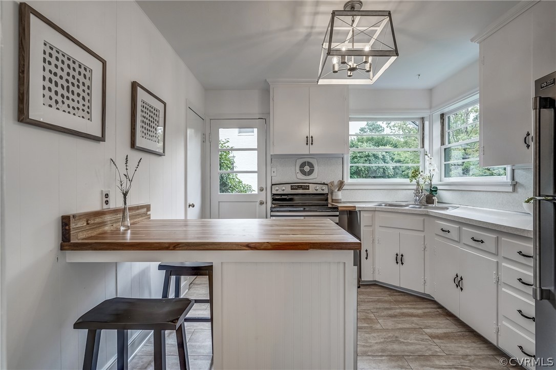 1606 Princeton Road Richmond, VA 23227 - Photo 9 of 37 a kitchen with sink a window and chairs