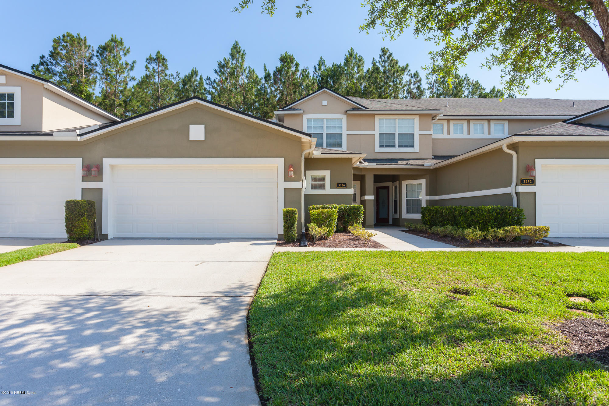 3256 Chestnut Ridge Way Orange Park, FL 32065 - Photo 1 of 39 a front view of a house with a yard and trees