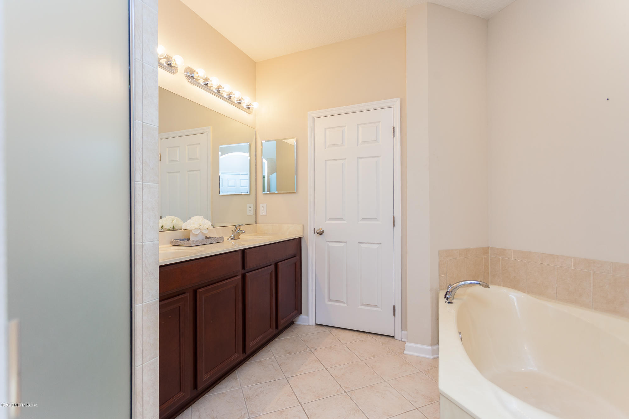 3256 Chestnut Ridge Way Orange Park, FL 32065 - Photo 11 of 39 a bathroom with a tub sink and mirror