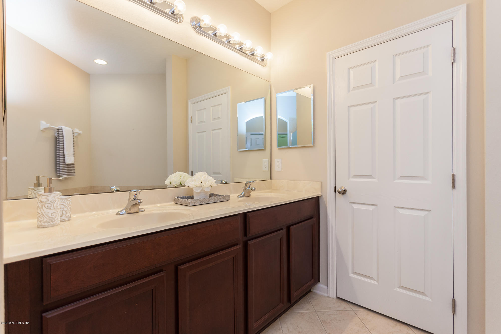 3256 Chestnut Ridge Way Orange Park, FL 32065 - Photo 13 of 39 a bathroom with double sink and a mirror