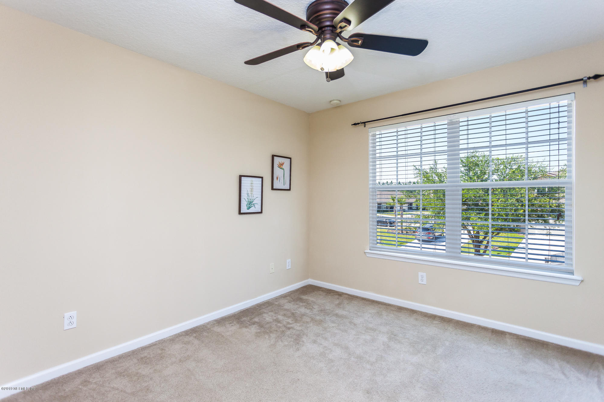 3256 Chestnut Ridge Way Orange Park, FL 32065 - Photo 19 of 39 an empty room with a window and a fan
