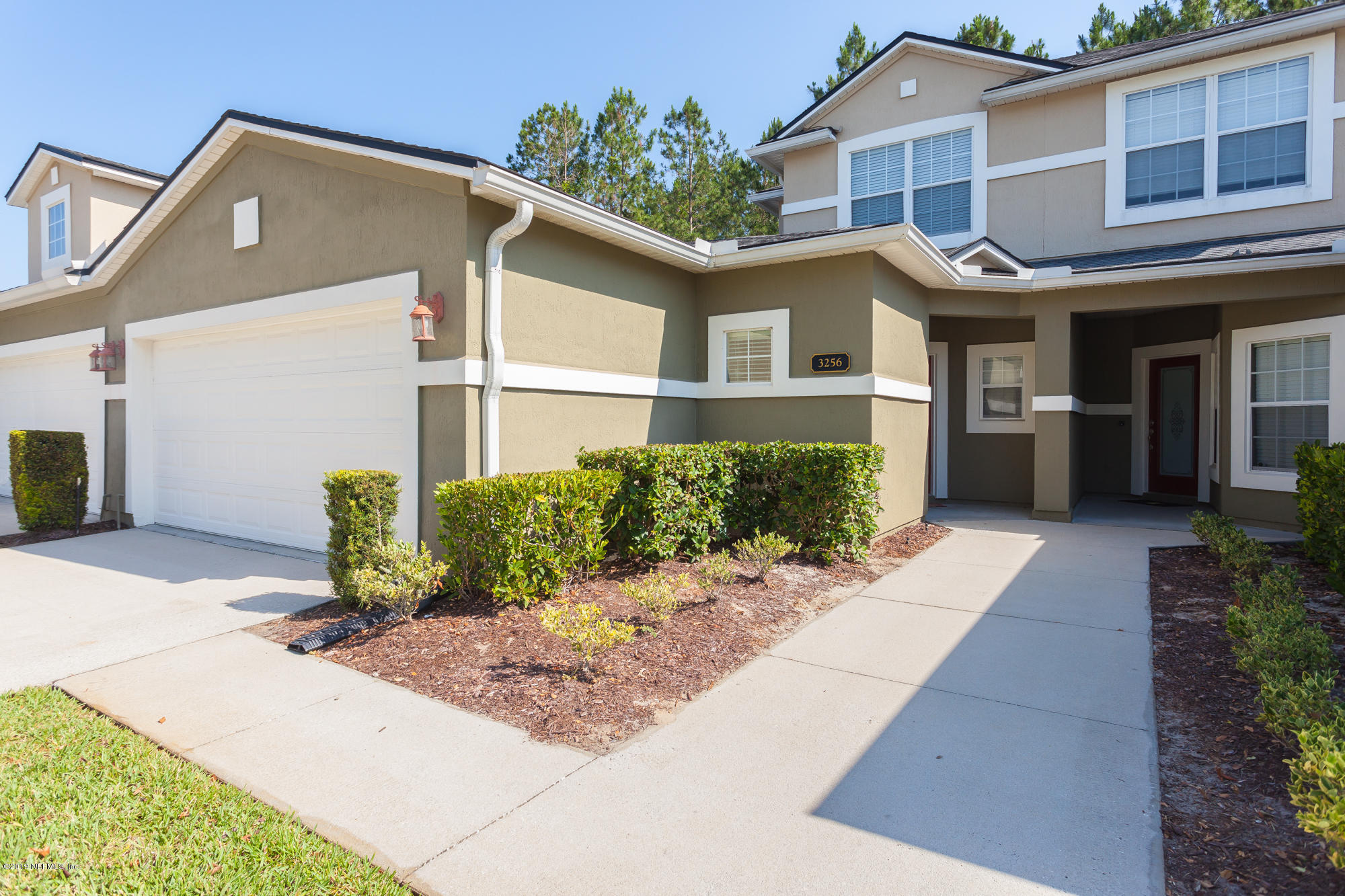 3256 Chestnut Ridge Way Orange Park, FL 32065 - Photo 2 of 39 a front view of a house with garden