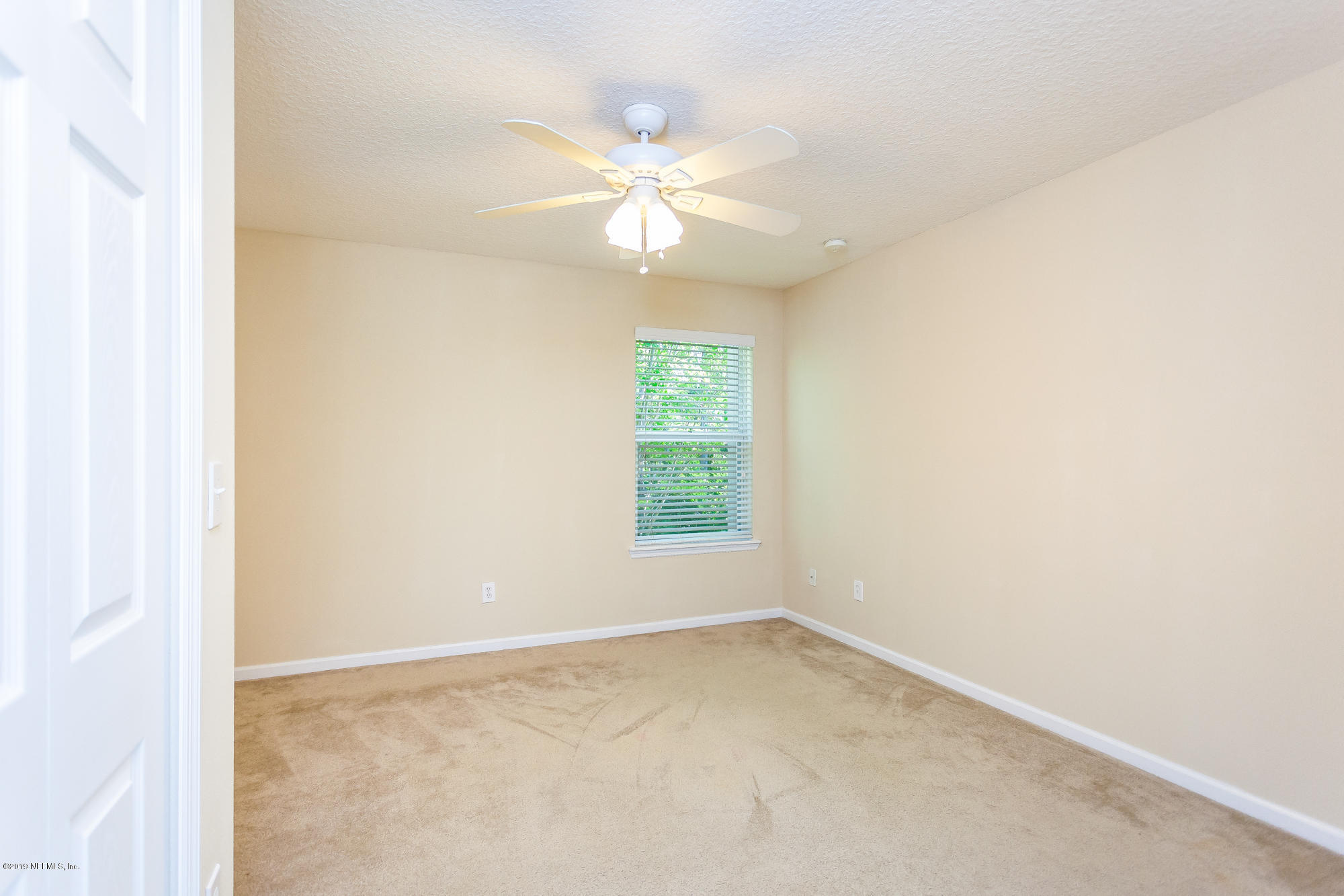 3256 Chestnut Ridge Way Orange Park, FL 32065 - Photo 21 of 39 an empty room with a window and a fan