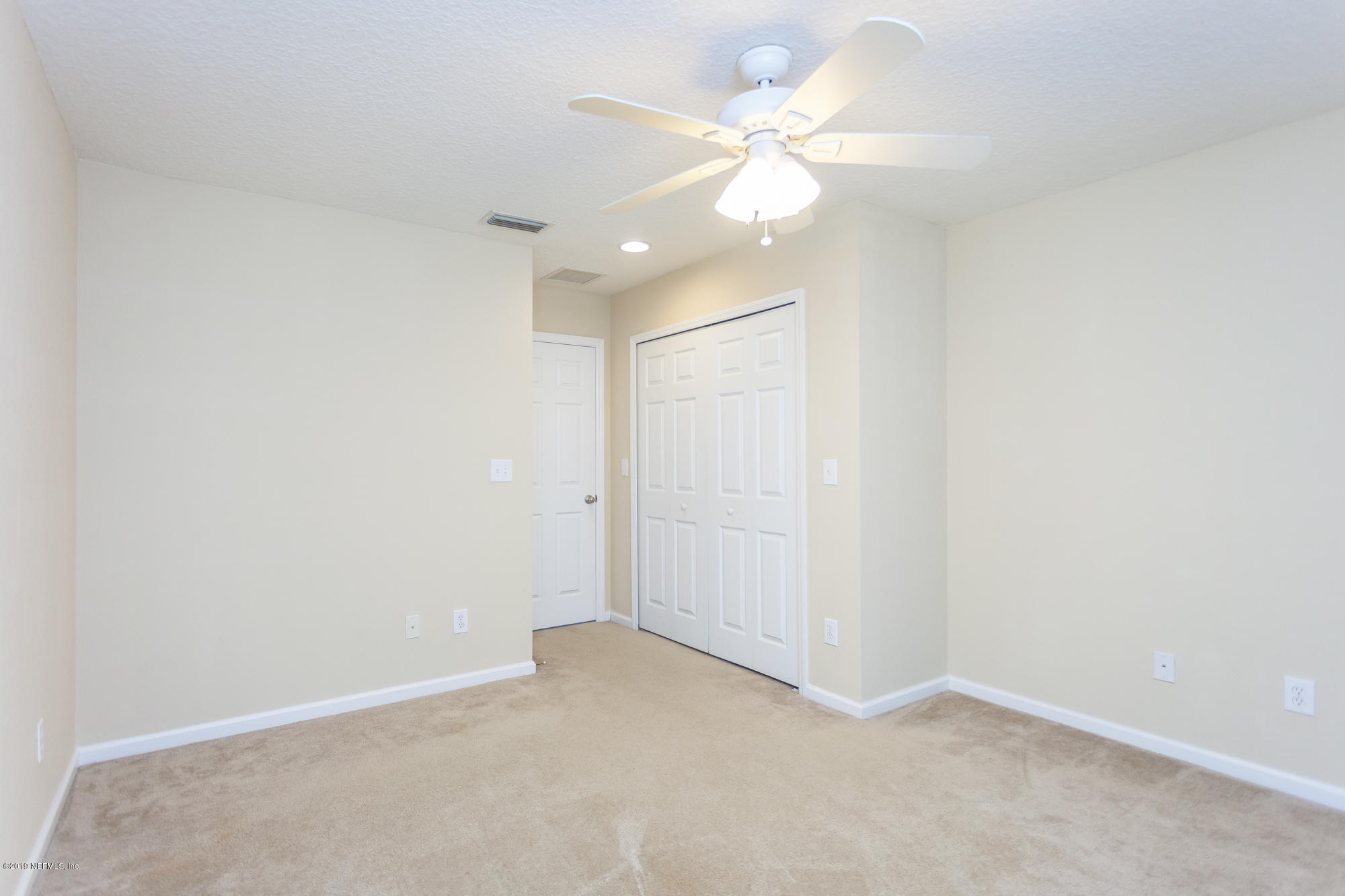 3256 Chestnut Ridge Way Orange Park, FL 32065 - Photo 22 of 39 an empty room with a ceiling fan and a window