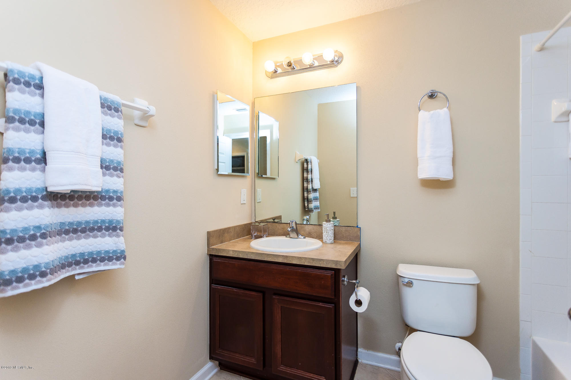 3256 Chestnut Ridge Way Orange Park, FL 32065 - Photo 23 of 39 a bathroom with a toilet sink and mirror