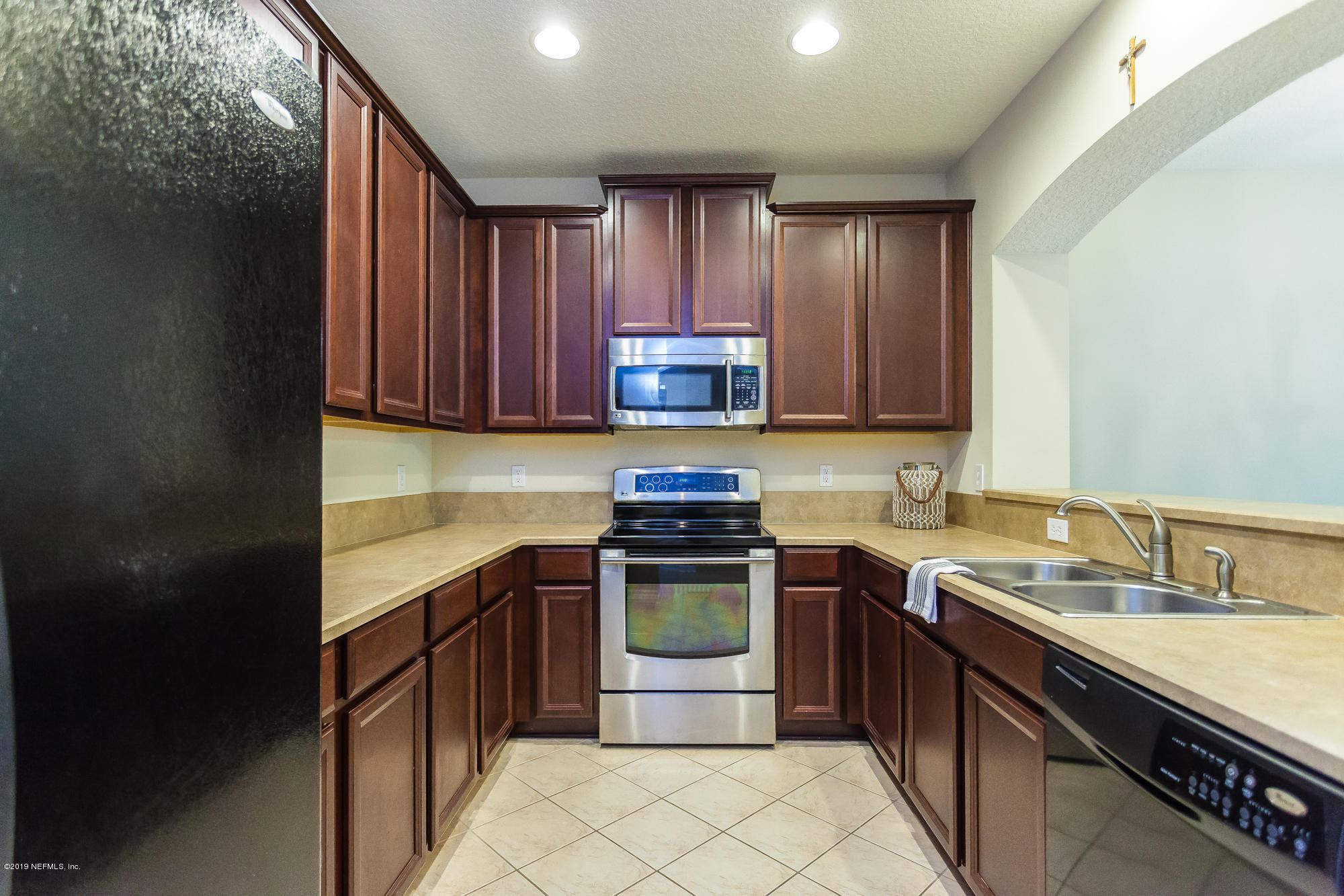 3256 Chestnut Ridge Way Orange Park, FL 32065 - Photo 4 of 39 a kitchen with a stove sink and cabinets