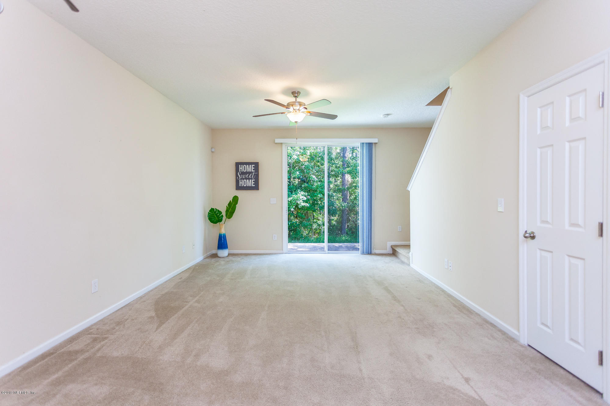 3256 Chestnut Ridge Way Orange Park, FL 32065 - Photo 6 of 39 a view of a big room with windows and chandelier fan
