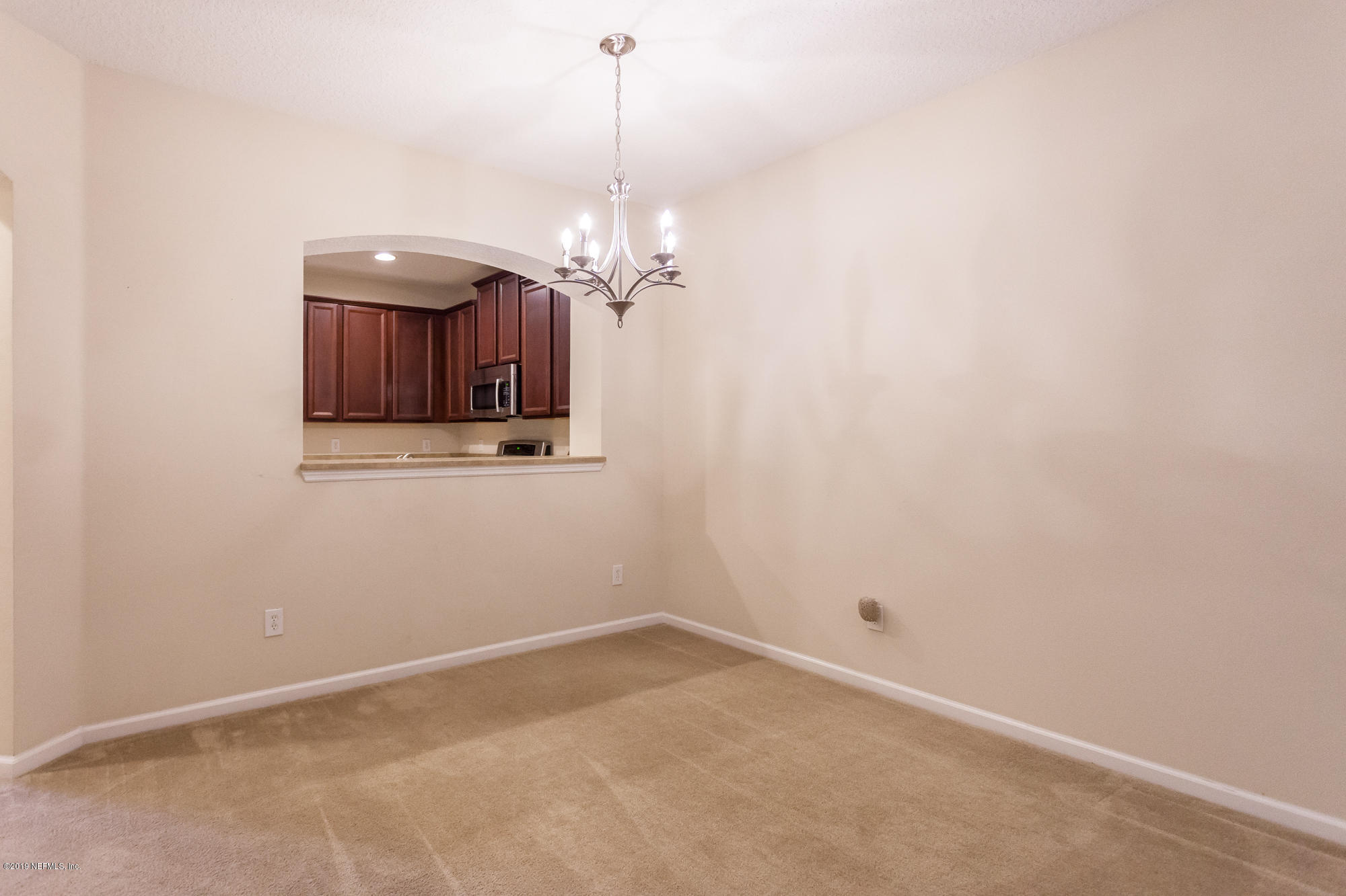 3256 Chestnut Ridge Way Orange Park, FL 32065 - Photo 8 of 39 a view of a room with a hanging light and kitchen