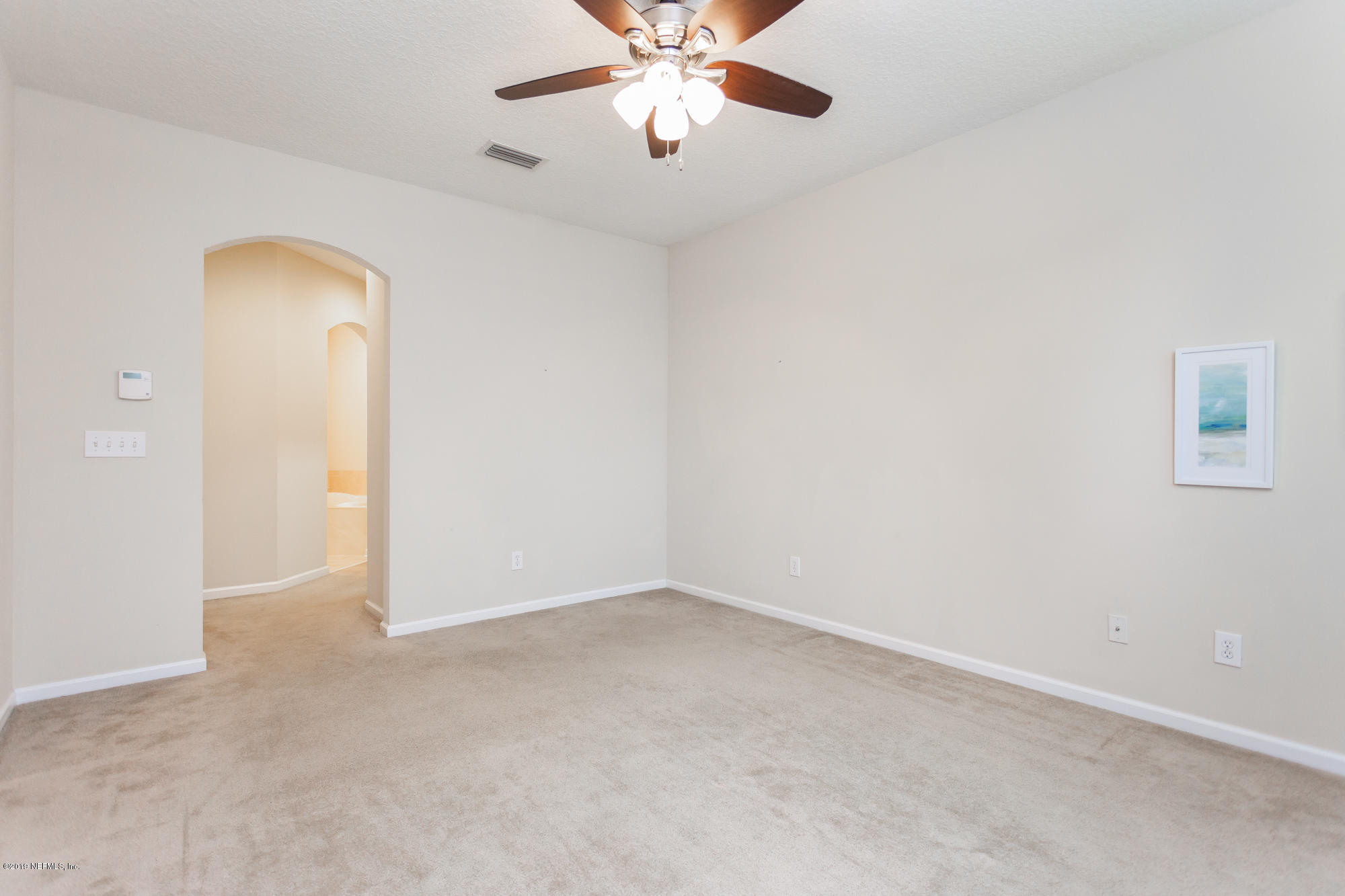3256 Chestnut Ridge Way Orange Park, FL 32065 - Photo 10 of 39 an empty room with closet and a chandelier fan
