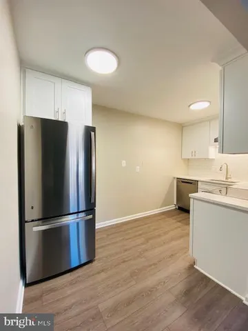 a kitchen with a refrigerator and a sink