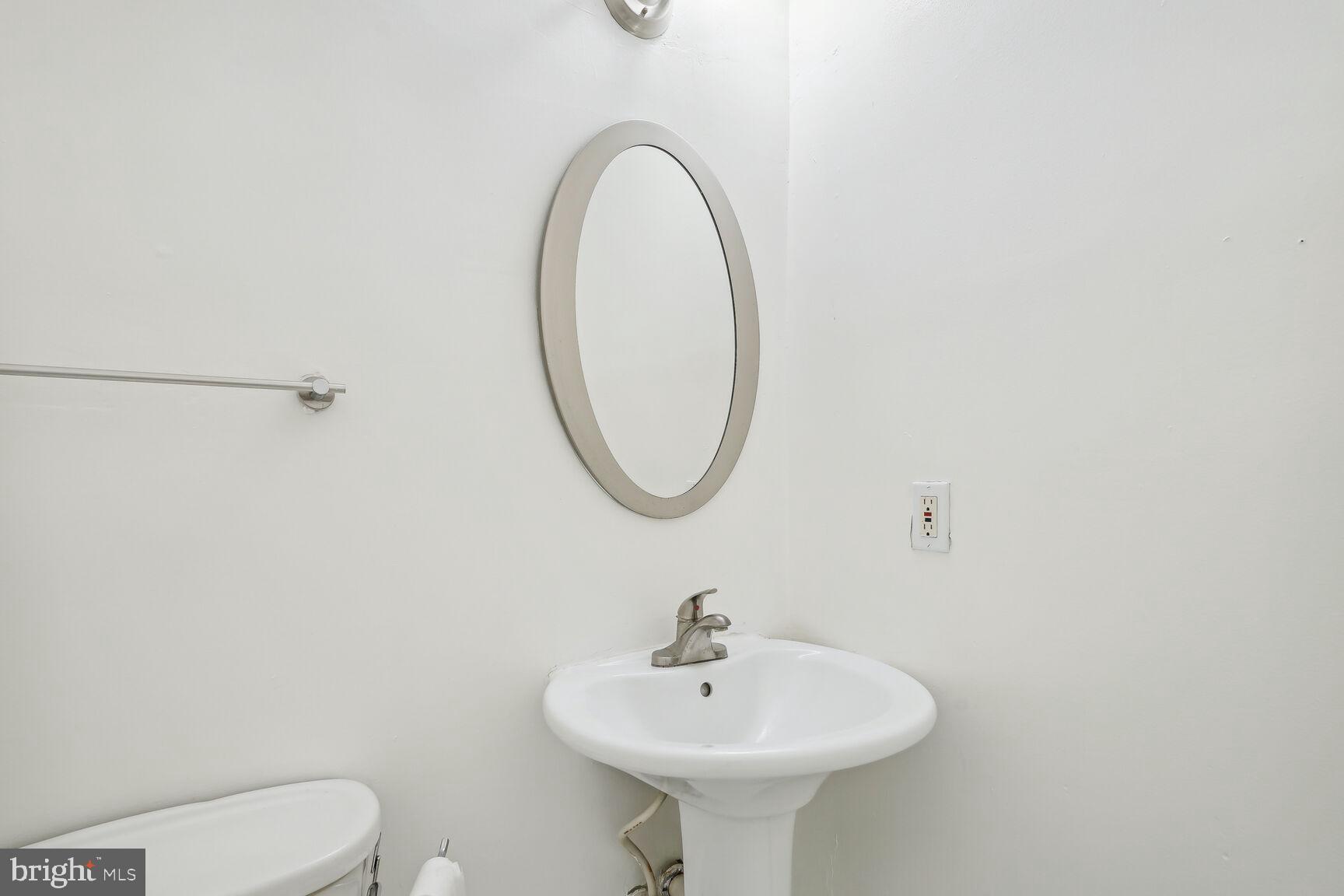 4528 4th Street Northwest Washington, DC 20011 - Photo 13 of 28 a bathroom with a sink a mirror and toilet