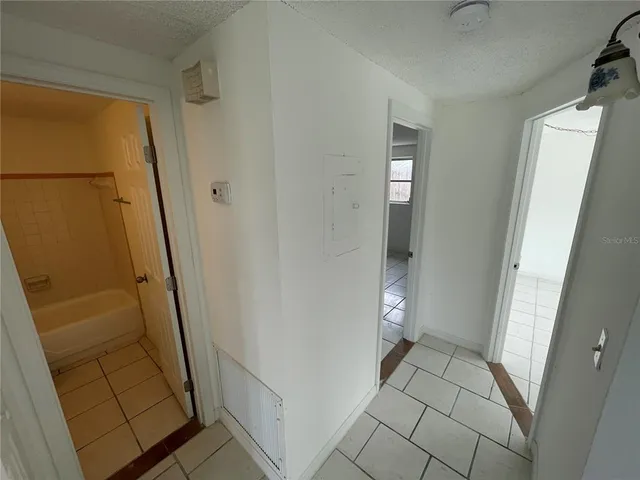 an empty room with a glass door shower