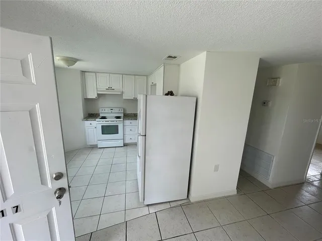 a utility room with cabinets washer and dryer