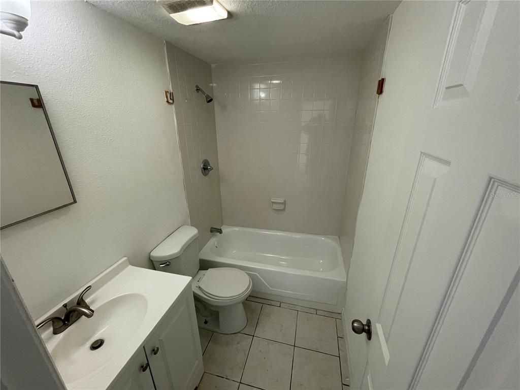 5317 Avery Road New Port Richey, FL 34652 - Photo 7 of 39 a bathroom with a sink toilet and shower