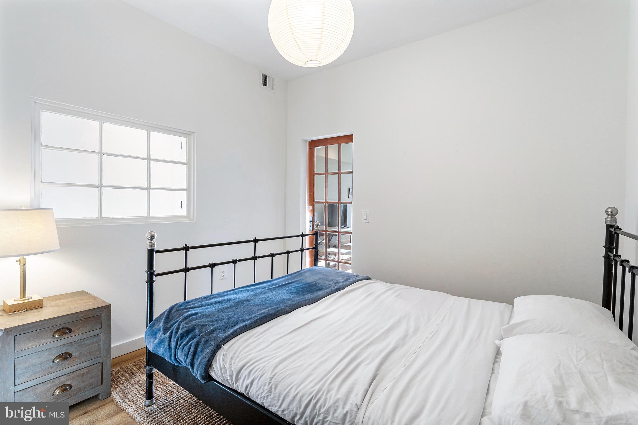 2465 18th Street Northwest, Unit 1 Washington, DC 20009 - Photo 12 of 17 a bedroom with a bed and a window
