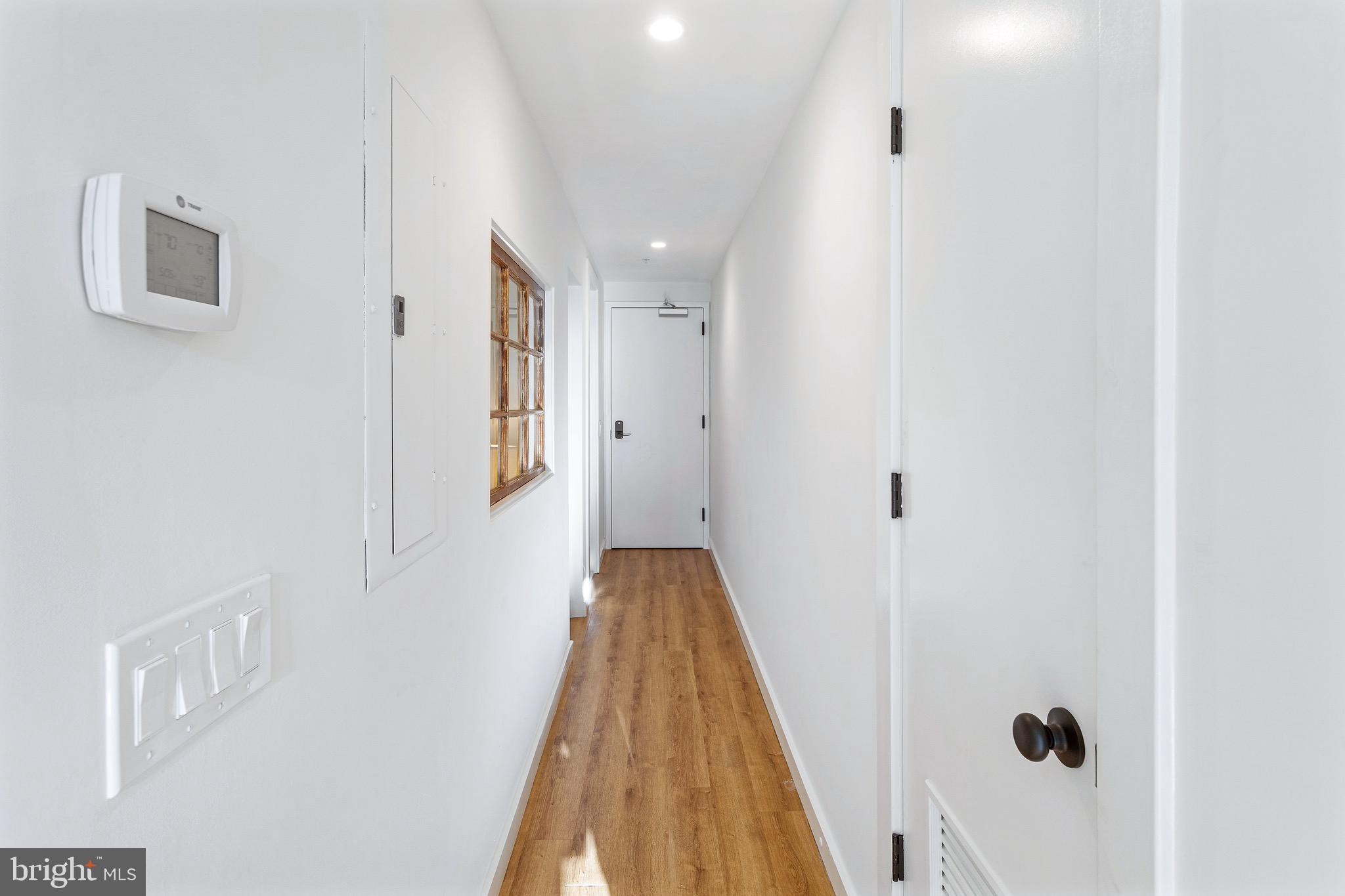 2465 18th Street Northwest, Unit 1 Washington, DC 20009 - Photo 17 of 17 a view of a hallway with wooden floor and staircase