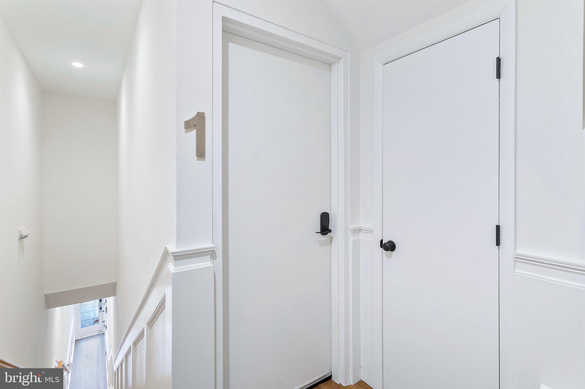 2465 18th Street Northwest, Unit 1 Washington, DC 20009 - Photo 2 of 17 a view of a hallway with a glass door
