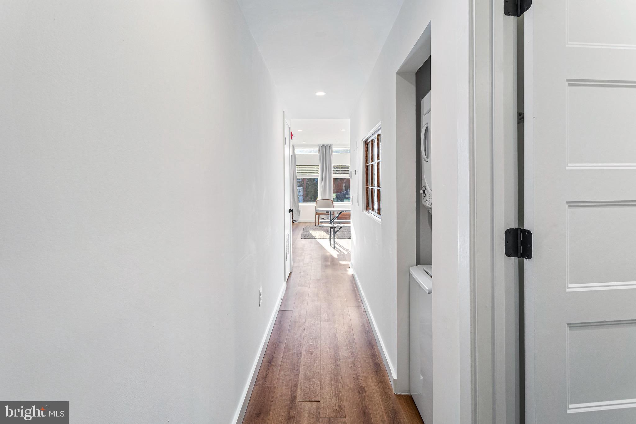 2465 18th Street Northwest, Unit 1 Washington, DC 20009 - Photo 3 of 17 a view of a hallway with wooden floor and a bathroom