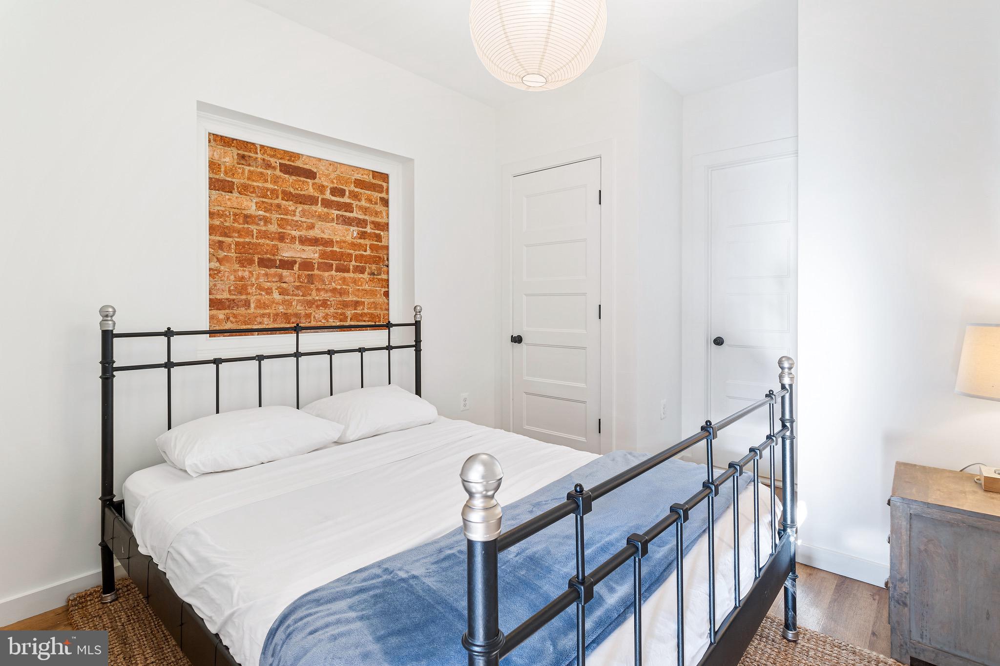2465 18th Street Northwest, Unit 1 Washington, DC 20009 - Photo 10 of 17 a bed sitting in a bedroom next to a window