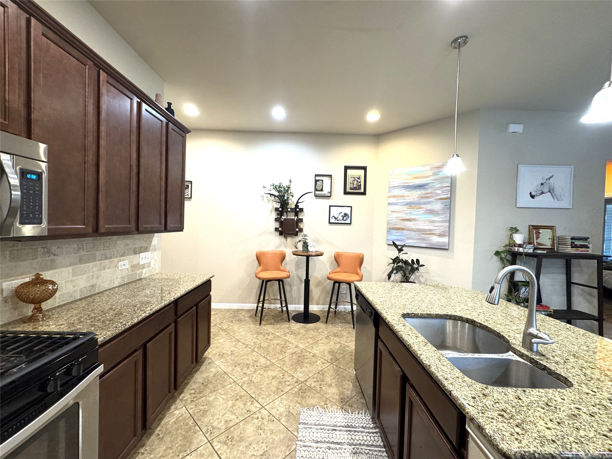 413 Anacua Loop, Unit 8 Manchaca, TX 78652 - Photo 1 of 23 Polished granite countertops and classic tile flooring define this spacious kitchen.
