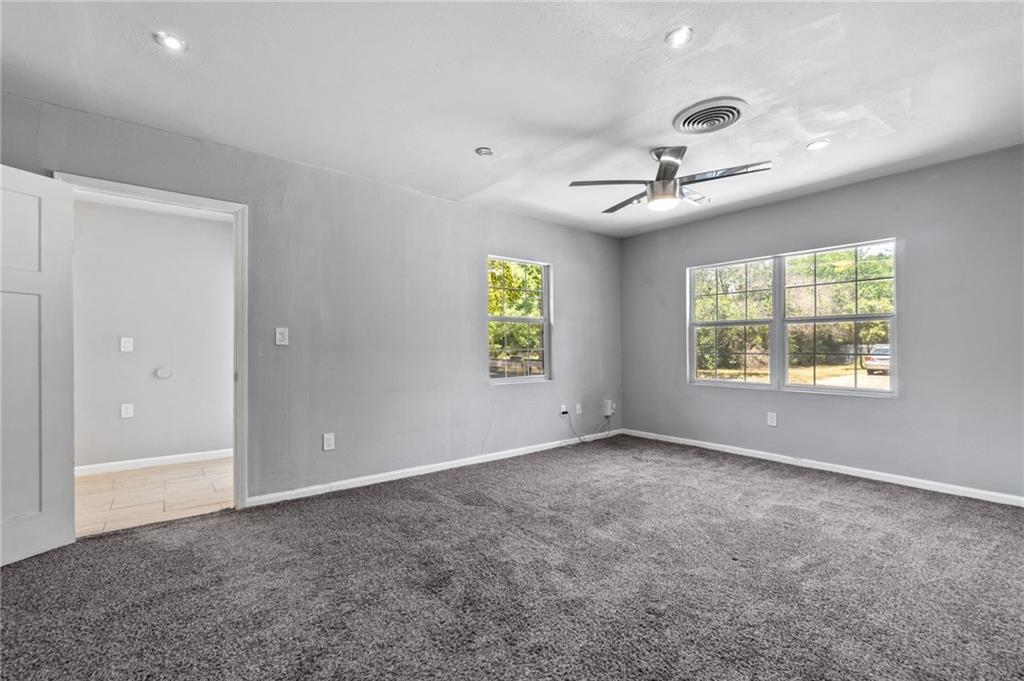 2105 Fortview Road Austin, TX 78704 - Photo 21 of 37 Well-lit room features soft carpeting and two windows offering pleasant outdoor views.