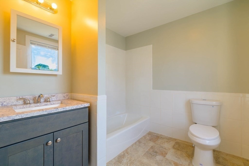 28-30 Chestnut Avenue, Unit 3 Boston, MA 02130 - Photo 12 of 17 a bathroom with a sink a toilet and mirror