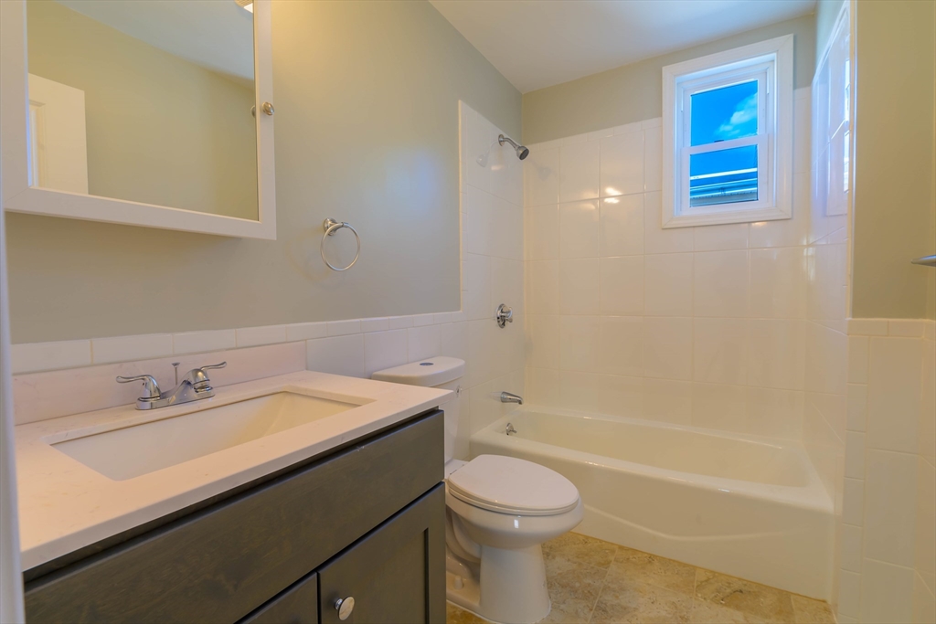 28-30 Chestnut Avenue, Unit 3 Boston, MA 02130 - Photo 14 of 17 a bathroom with a sink a toilet and shower