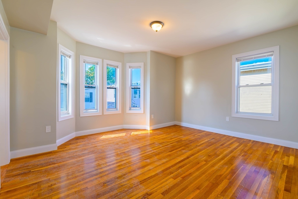 28-30 Chestnut Avenue, Unit 3 Boston, MA 02130 - Photo 2 of 17 a view of an empty room with wooden floor and a window