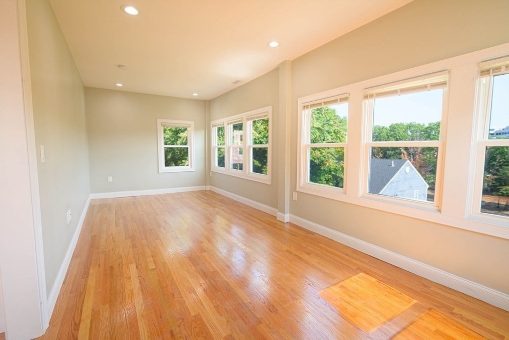 28-30 Chestnut Avenue, Unit 3 Boston, MA 02130 - Photo 3 of 17 a view of an empty room with a window and wooden floor