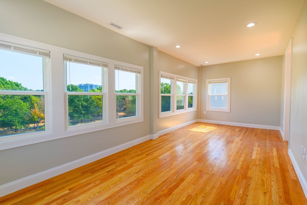 28-30 Chestnut Avenue, Unit 3 Boston, MA 02130 - Photo 4 of 17 a view of an empty room with wooden floor and a window
